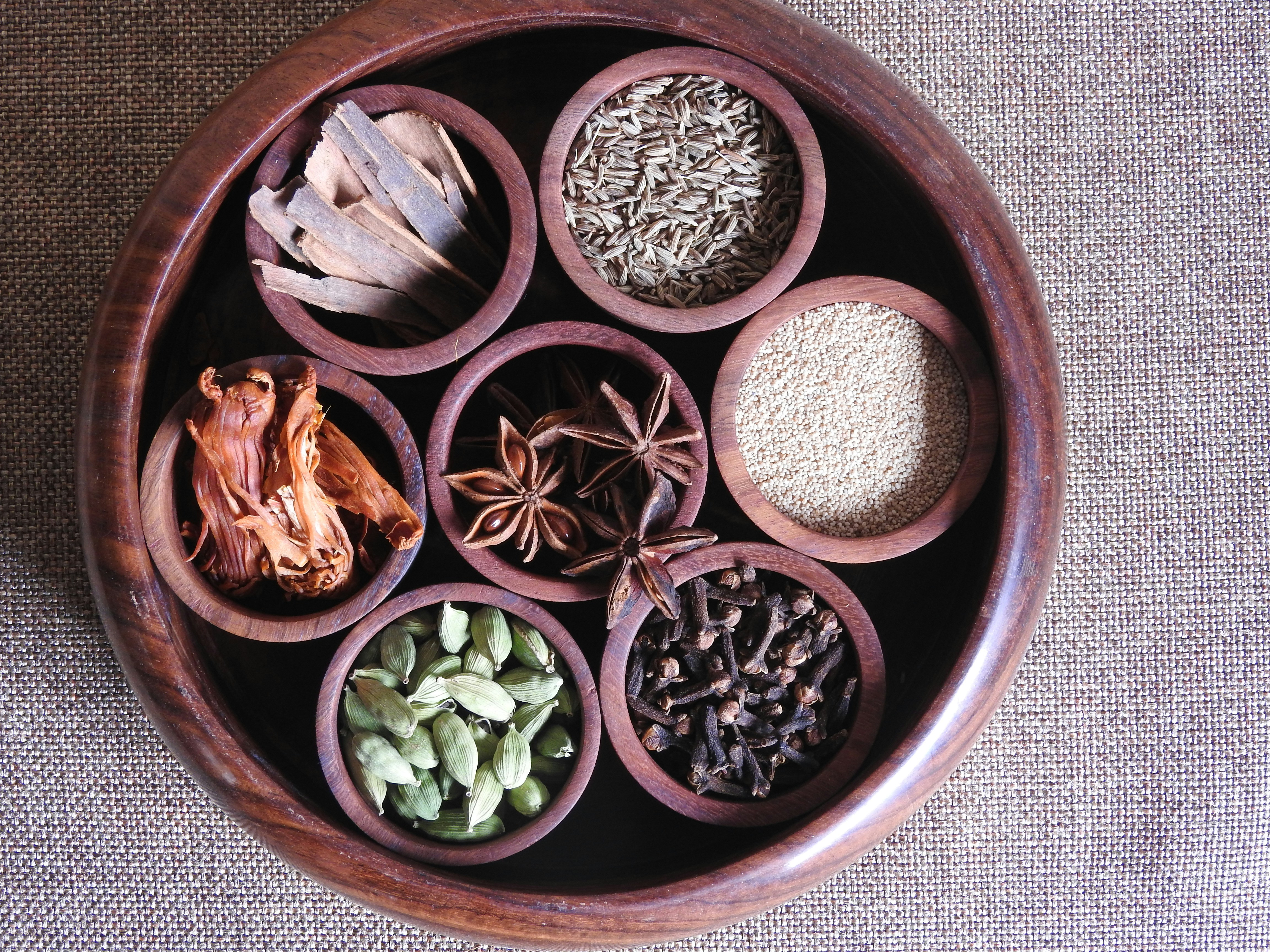 Various global spices and ingredients arranged in bowls